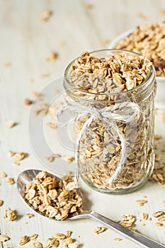 Almond Granola In Glass Jar With Spilled