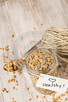 Almond Granola With Heart Healthy Tag On Jar And Spoon