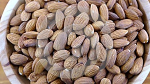 Almond kernel in a bowl. Background view from above. Healthy food.