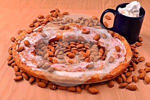 Almond Flavored Kringle on a bed of nuts with hot chocolate