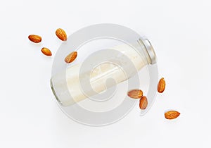 Almond milk and almond seeds over white background, vegetable milk, the concept of proper nutrition raw food vegan