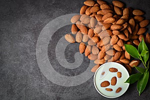Almond milk and Almonds nuts on dark background, Delicious sweet almonds on table, roasted almond nut for healthy food and snack