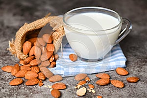 Almond milk and Almonds nuts on on sack background, Delicious sweet almonds on the table, roasted almond nut for healthy food and