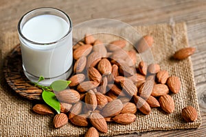 Almond milk and Almonds nuts on on sack background, Delicious sweet almonds on the table, roasted almond nut for healthy food and