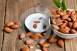 Almond milk and Almonds nuts on on white bowl background, Delicious sweet almonds on the table, roasted almond nut for healthy