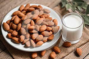 Almond milk and Almonds nuts on on white plate background, Delicious sweet almonds on the table, roasted almond nut for healthy