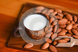 Almond milk and Almonds nuts on wooden background, Delicious sweet almonds on the table, roasted almond nut for healthy food and