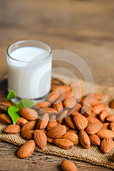 Almond milk and Almonds nuts wooden background, Delicious sweet almonds on table, roasted almond nut for healthy food and snack