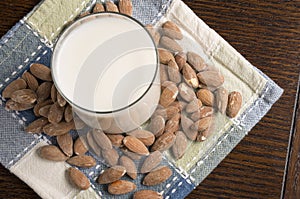 Almond Milk with almonds on table - Overhead