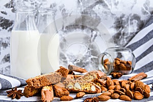 Almond milk in bottles with Cantuccini Cookie Biscuits with Almonds, cinnamon and anise, almond seeds