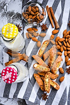 Almond milk in bottles with Cantuccini Cookie Biscuits with Almonds, cinnamon and anise, almond seeds