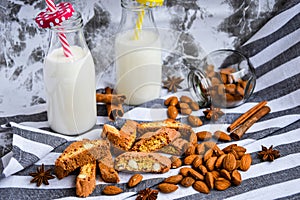 Almond milk in bottles with Cantuccini Cookie Biscuits with Almonds, cinnamon and anise, almond seeds