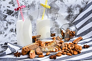 Almond milk in bottles with Cantuccini Cookie Biscuits with Almonds, cinnamon and anise, almond seeds