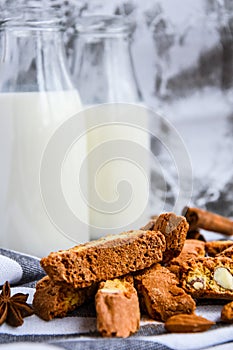 Almond milk in bottles with Cantuccini Cookie Biscuits with Almonds, cinnamon and anise, almond seeds