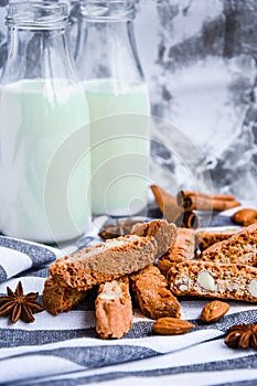 Almond milk in bottles with Cantuccini Cookie Biscuits with Almonds, cinnamon and anise, almond seeds