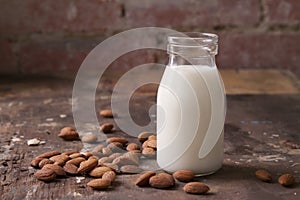 Almond milk in a glass jar with almonds