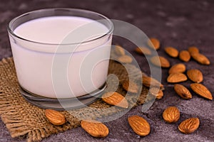 Almond milk in a transparent jug on a white background.
