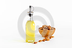 Almond nut oil in glass bottle with almond nuts. Extra virgin essence oil