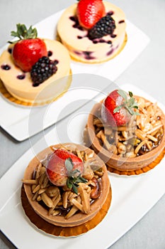 Almond nut tart on top fresh strawberry and blueberry cheese