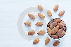 Almond nut in wood bowl on white table background