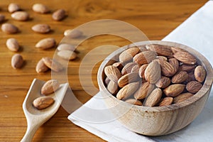 Almond nut in wood bowl on wooden table background