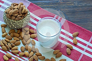 Almond nuts and glass of dairy-free almond milk. Copy space