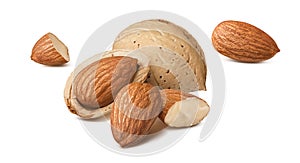 Almond nuts in shells in small piles isolated on white background