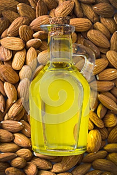 Almond oil in bottle on almond background