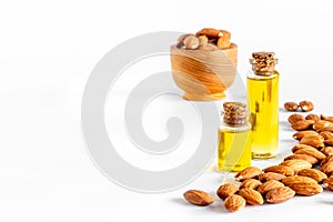Almond oil in bottle with almond nuts. Extra virgin essence oil