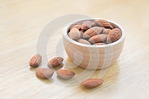 Almond seeds in wooden cup.