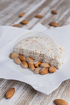 Almond vegan cheese and almonds on a wooden table