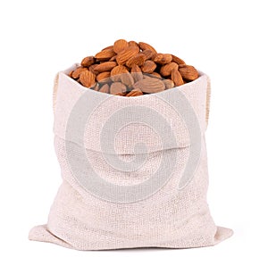 Almonds in bag from sacking isolated on white background