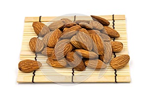 Almonds on a bamboo, on a white background.