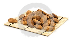 Almonds on a bamboo, on a white background.