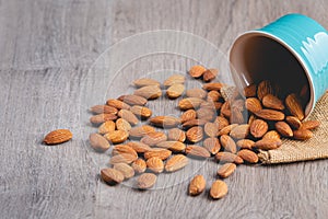 Almonds in the blue cup on wooden table photo