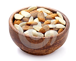 Almonds in brown bowl isolated on white background