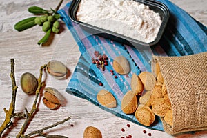 Almonds in a cloth bag and container with flour II photo