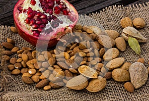 Almonds in a mortar and pomegranate fruit.