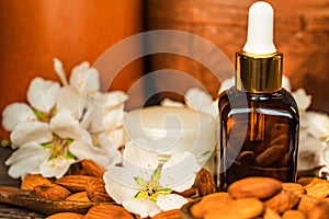 Almonds, oil, face cream and white flowers