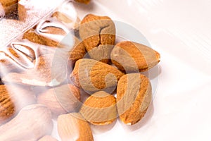 Almonds packages in plastic packaging on white