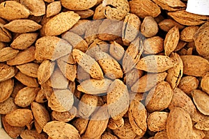 Almonds. Raw organic almonds as a background. Almond nuts with shells. Healthy food concept. Vegetarian. Nuts pattern