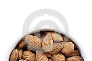 Almonds on a white background, or on a plain wooden table.