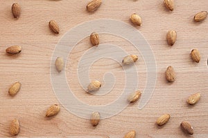 Almonds on a white background, or on a plain wooden table.