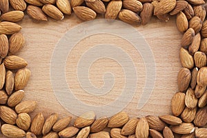 Almonds on a white background, or on a plain wooden table.