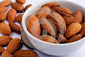 almonds on white plate macro on nuts background