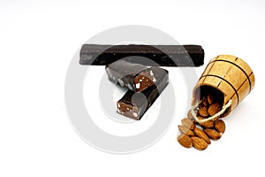 Almonds in a wooden barrel and chocolate bar