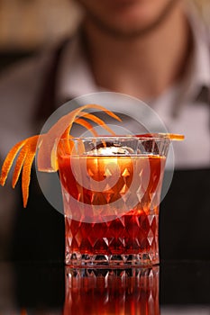 Alocohol cocktail negroni on black surface.