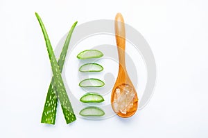 Aloe vera fresh leaves with slices and aloe vera gel on wooden spoon.