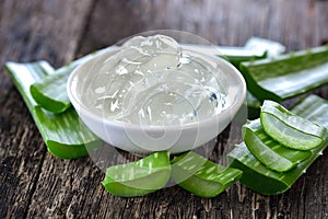 Aloe vera gel in bowl with on wooden table