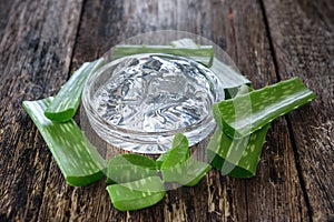 Aloe vera gel in bowl with on wooden table